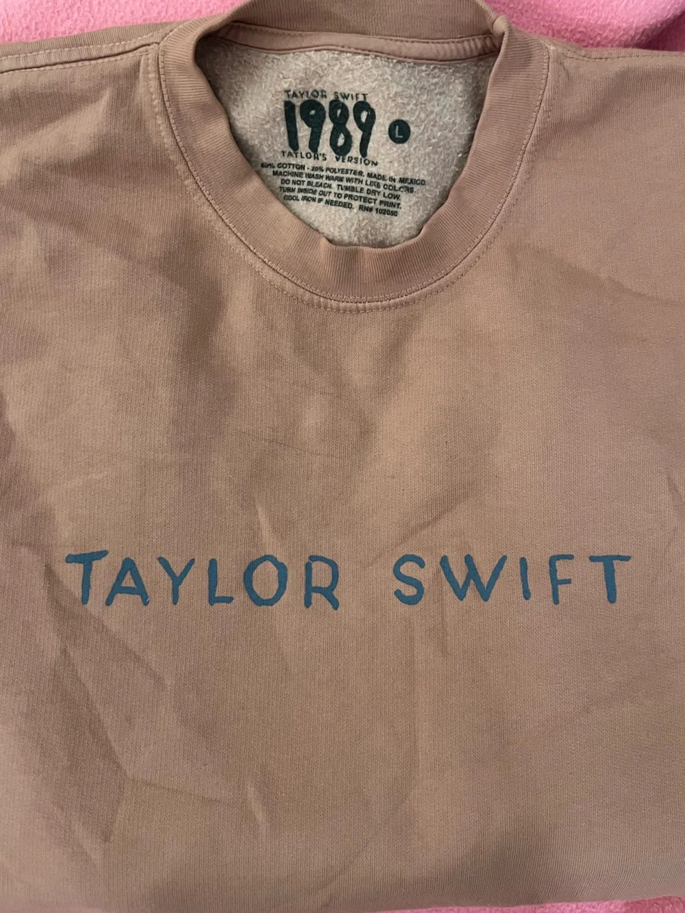 Taylor Swift pink crewneck with blue logo